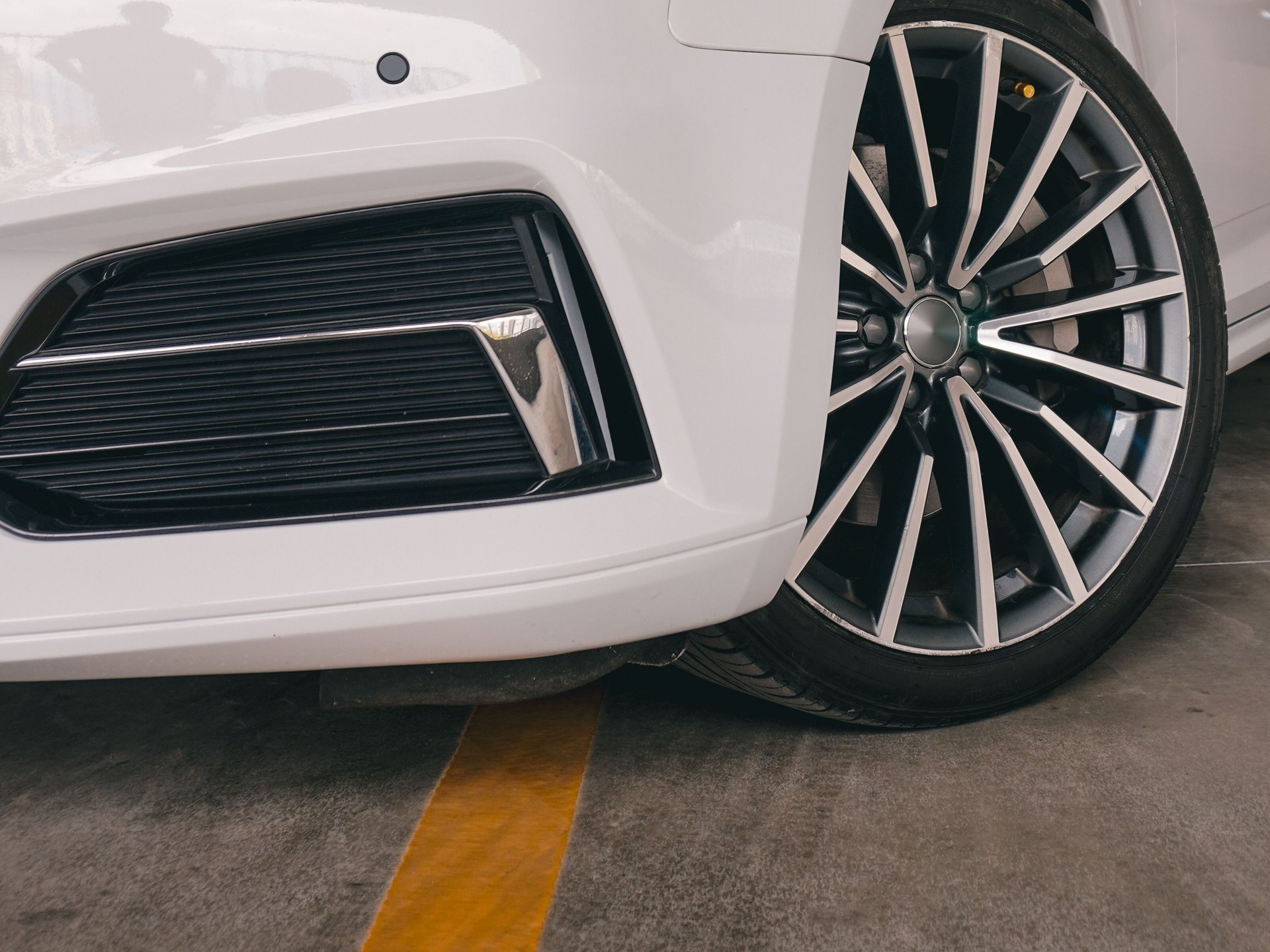 Front lower bumper, air intake and air dam of a car, low angle — representative image